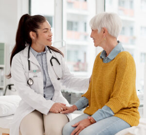 ABW Medical doctor sitting with female patient